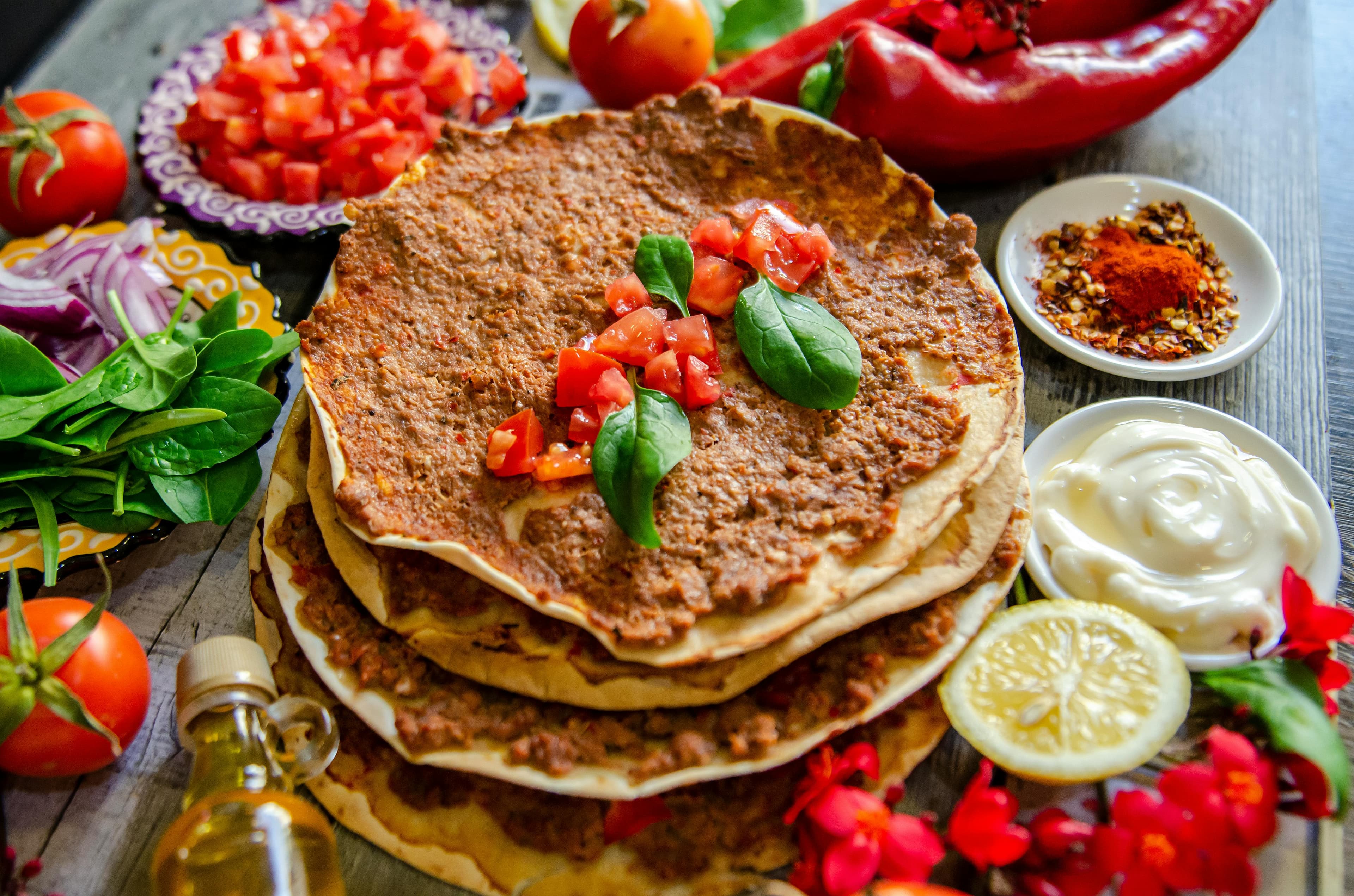 Lahmacun served with lemon and greens